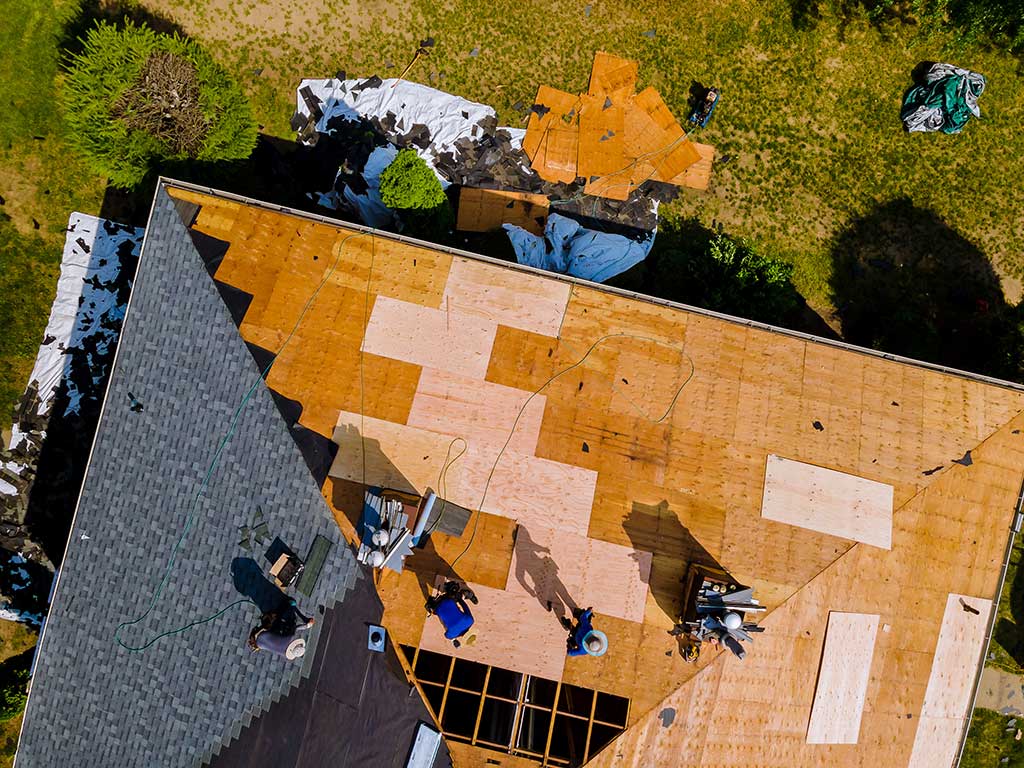 Roof construction repairman on a residential apartment